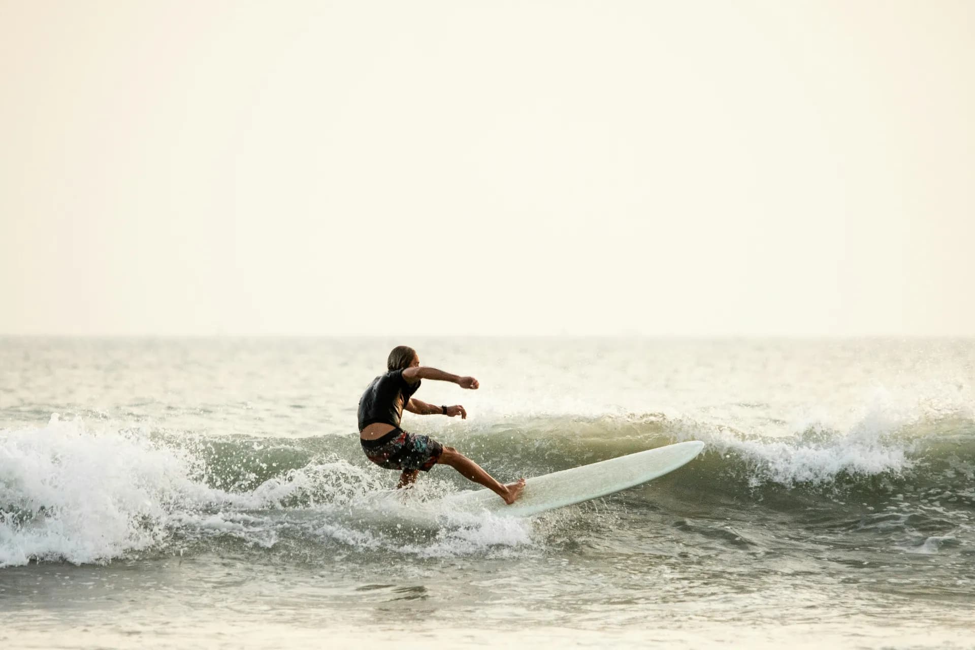 Surfer riding a wave at Arugam Bay, Sri Lanka's premier surf destination