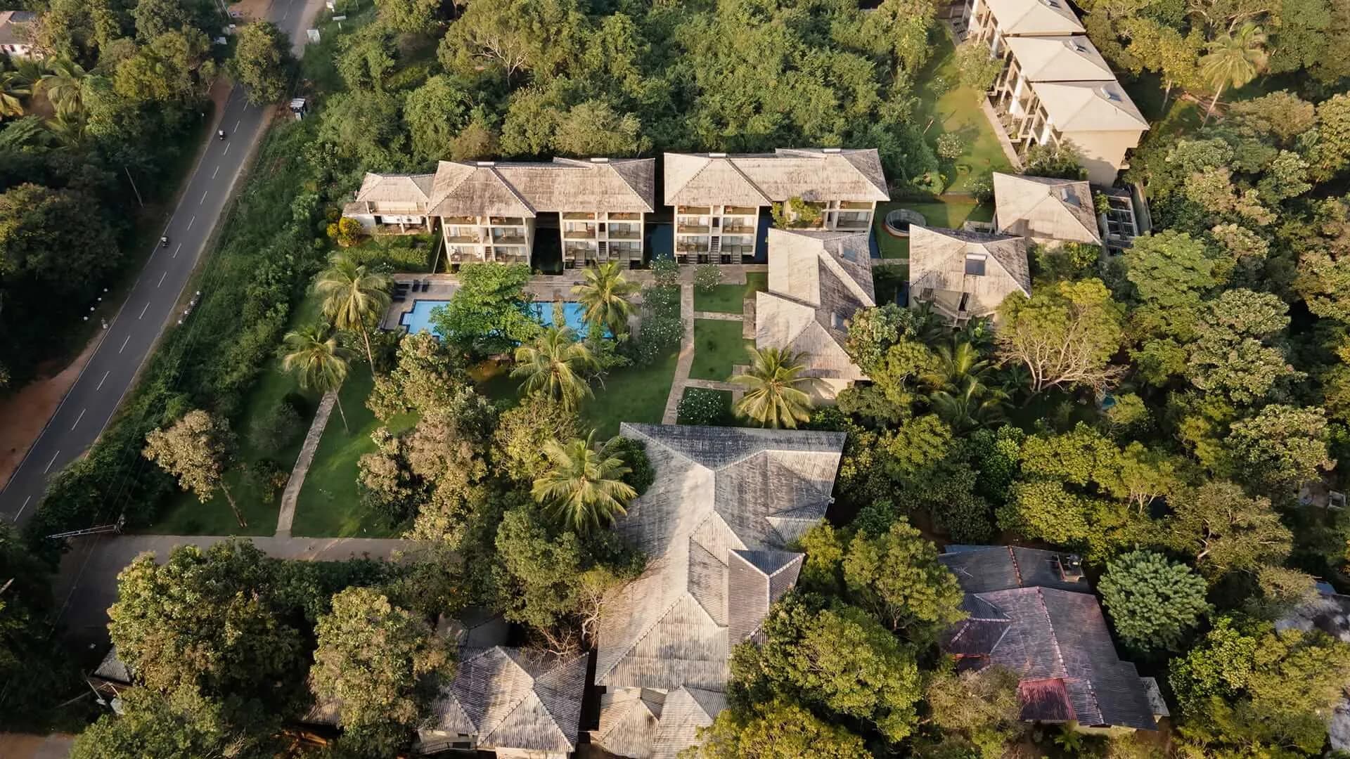 Oak Ray hotel garden with a tranquil pool surrounded by tropical greenery