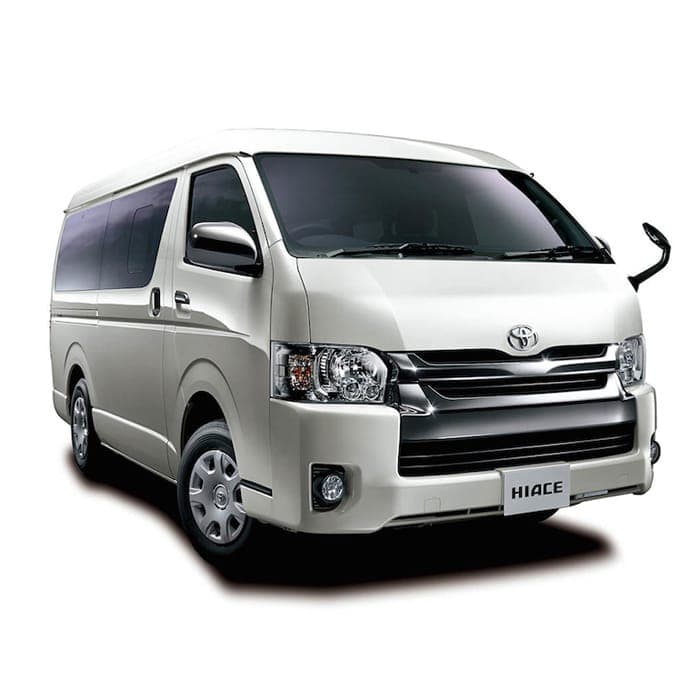 White deluxe passenger van on a mountain road